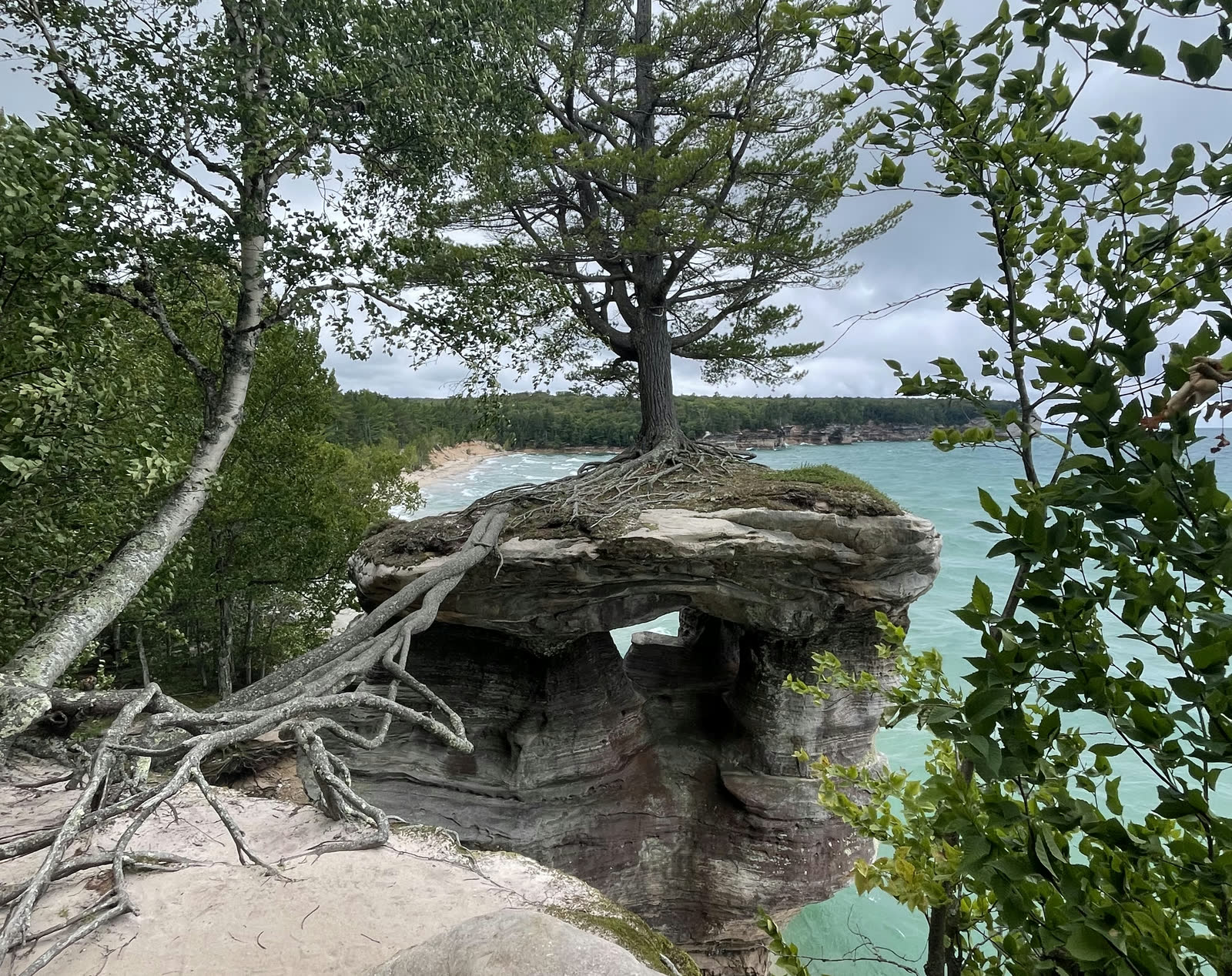 Chapel Rock and its lone pine above the turquoise water of Lake Superior at Pictured Rocks National Lakeshore.
